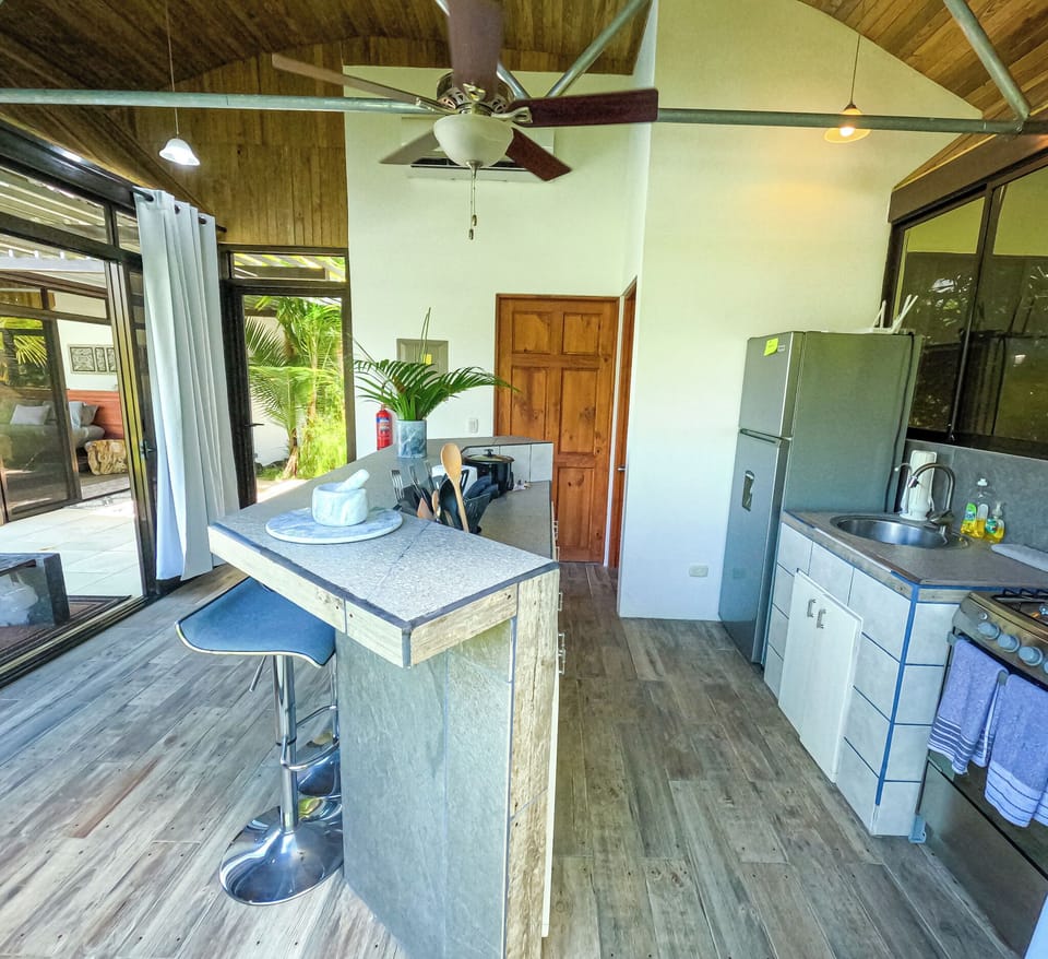 fully stocked kitchen with bar seating