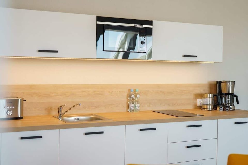 Cook and dine in style with the modern kitchenette and dining area.