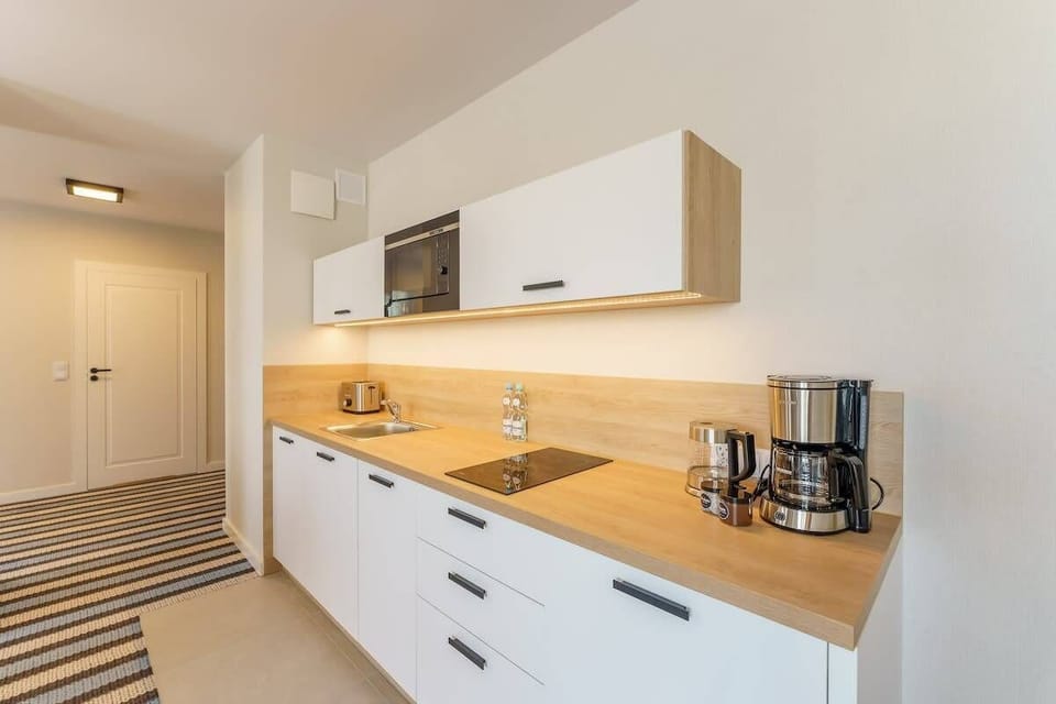 The sleek design of the kitchenette blending seamlessly with the living area.