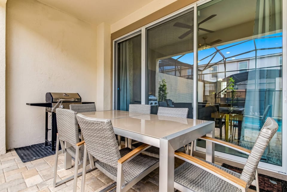 Step outside to your private patio, featuring a sleek outdoor dining set and a grill perfect for al fresco meals. Large sliding glass doors invite natural light, creating a bright and airy atmosphere for your outdoor gatherings.