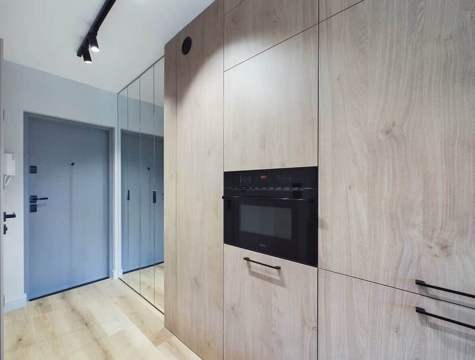 Compact and fully equipped with a stove, sink, and ample storage. Under-cabinet lights add functionality and elegance.