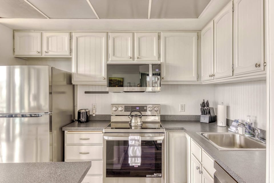 Functional kitchen equipped with essential appliances, offering a clean, practical space for easy meal prep during your stay.