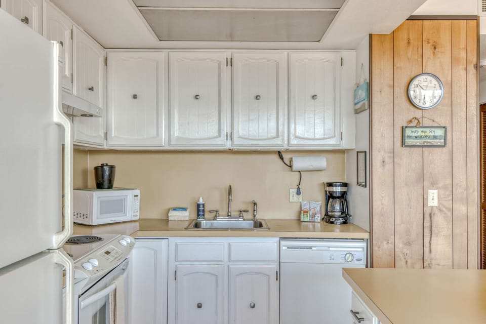 Functional kitchen providing essential appliances creating a clean and practical cooking space.