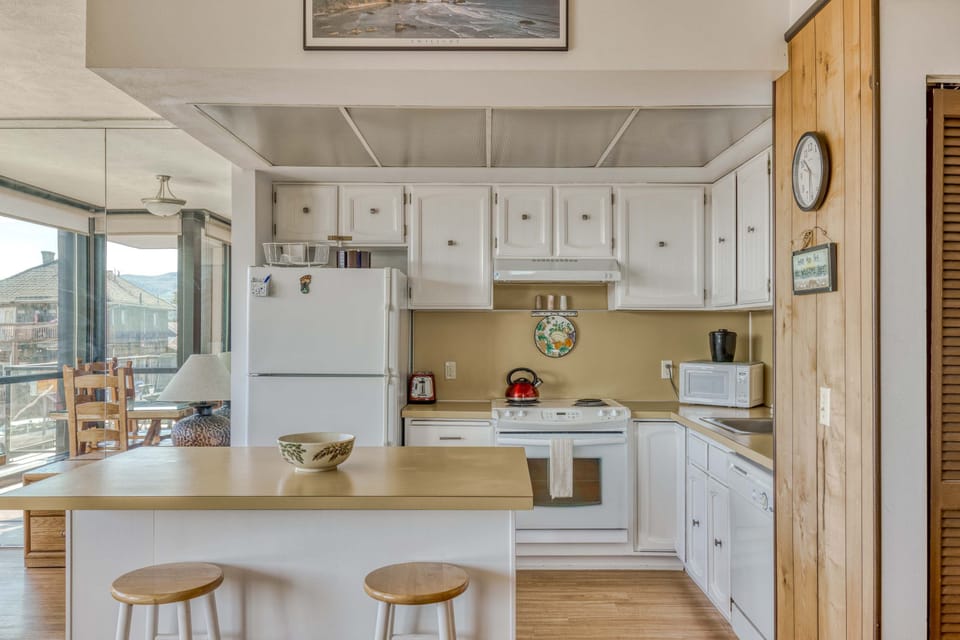 Functional kitchen providing essential appliances creating a clean and practical cooking space.