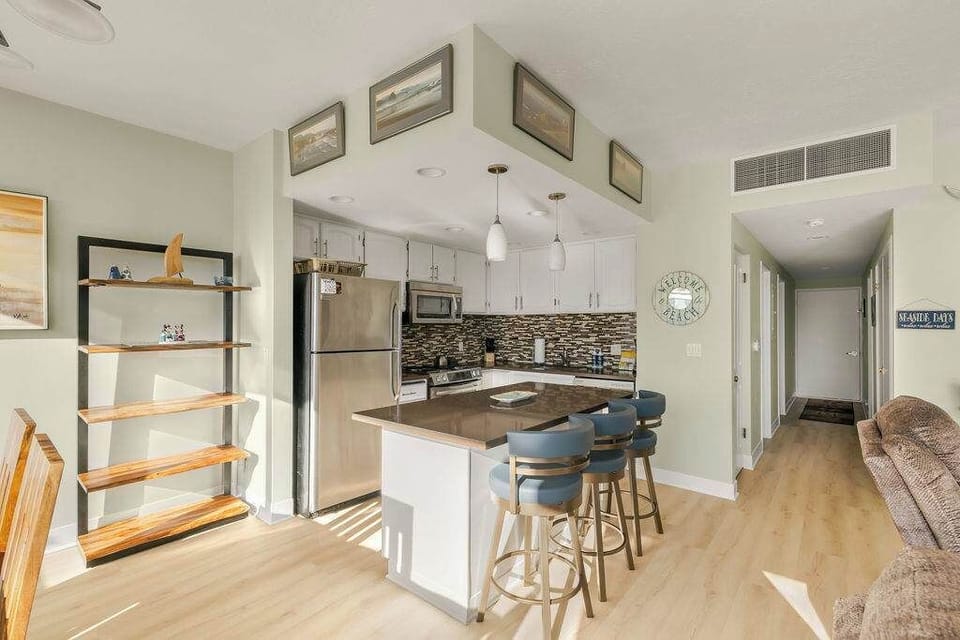 Well-equipped kitchen with island seating makes meals easy and social during your stay.