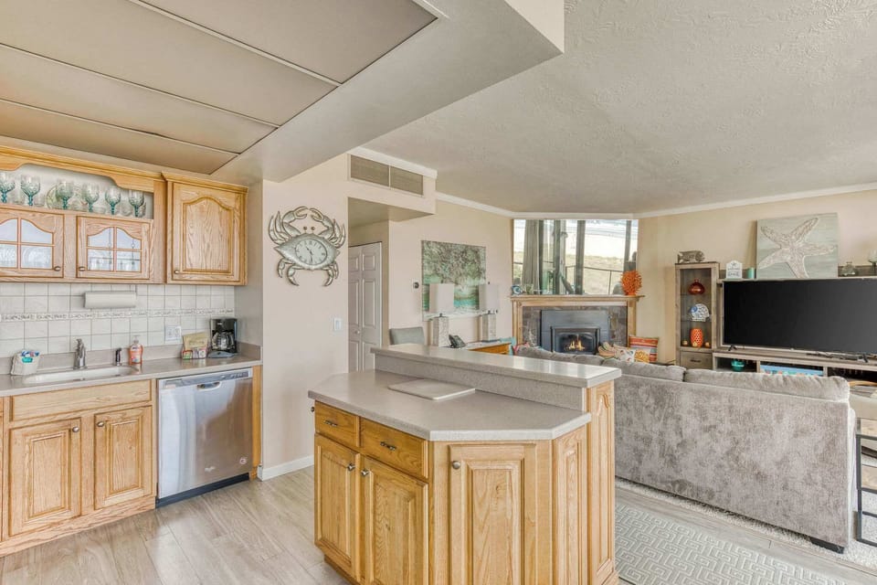 Open concept living! Fully equipped kitchen & cozy fireplace make this the perfect space to relax and entertain.
