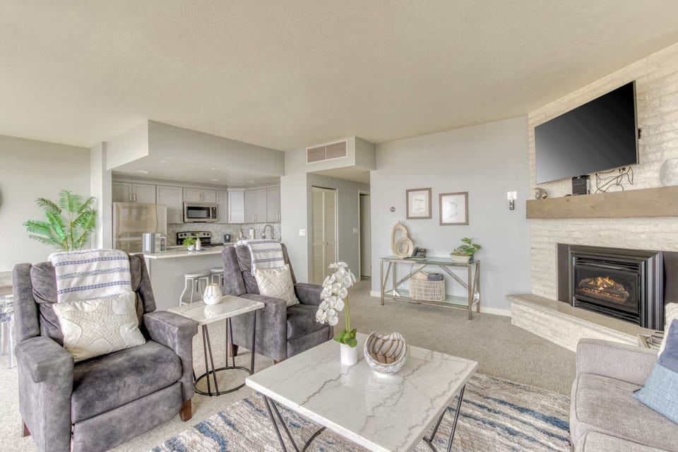 A modern, open-concept living space with large windows, cozy seating, a spacious dining area, and a bright, inviting atmosphere.