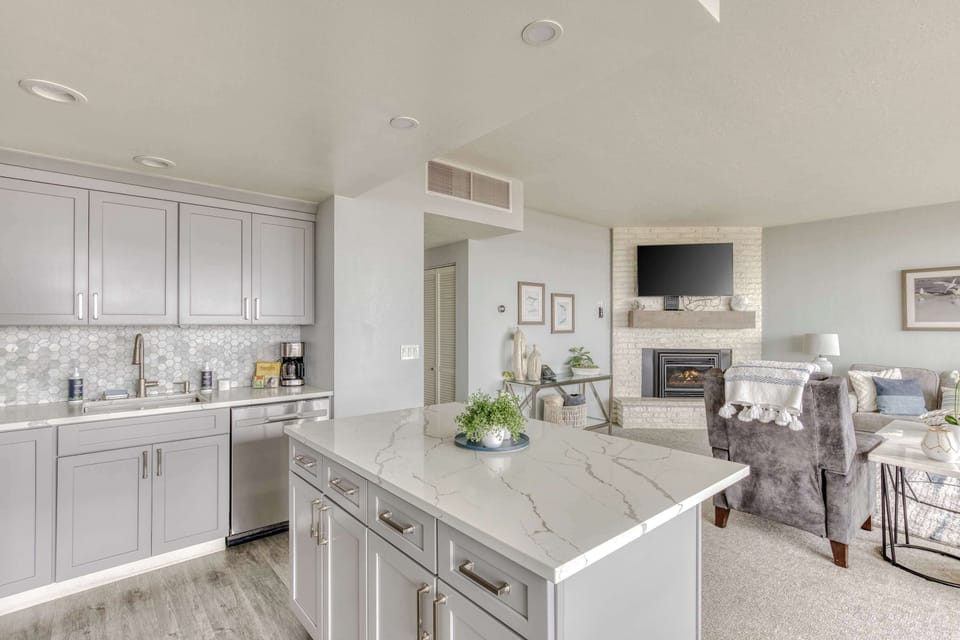 Gather 'round the island! Ample prep space & seating, plus an open floor plan means no one misses the fun. 
