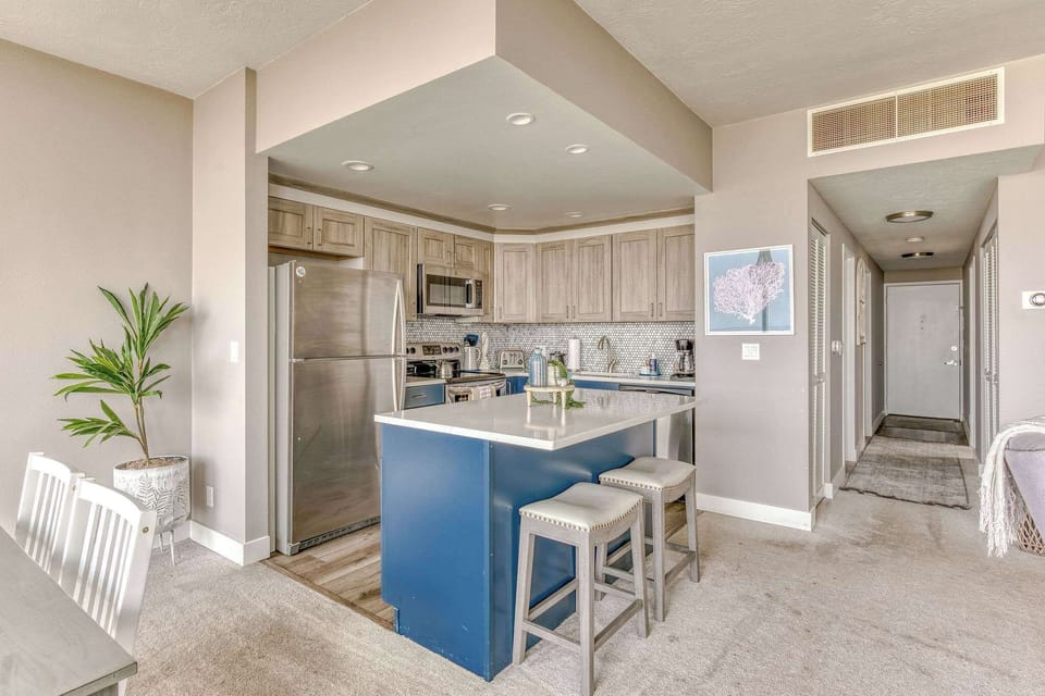 The island provides ample space to prep while also providing seating for company. Open floor plan means no one is missing out on the festivities!