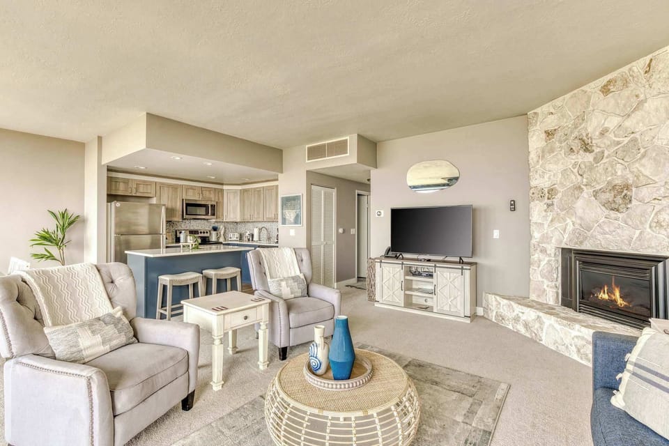 A modern, open-concept living space with large windows, cozy seating, a spacious dining area, and a bright, inviting atmosphere.