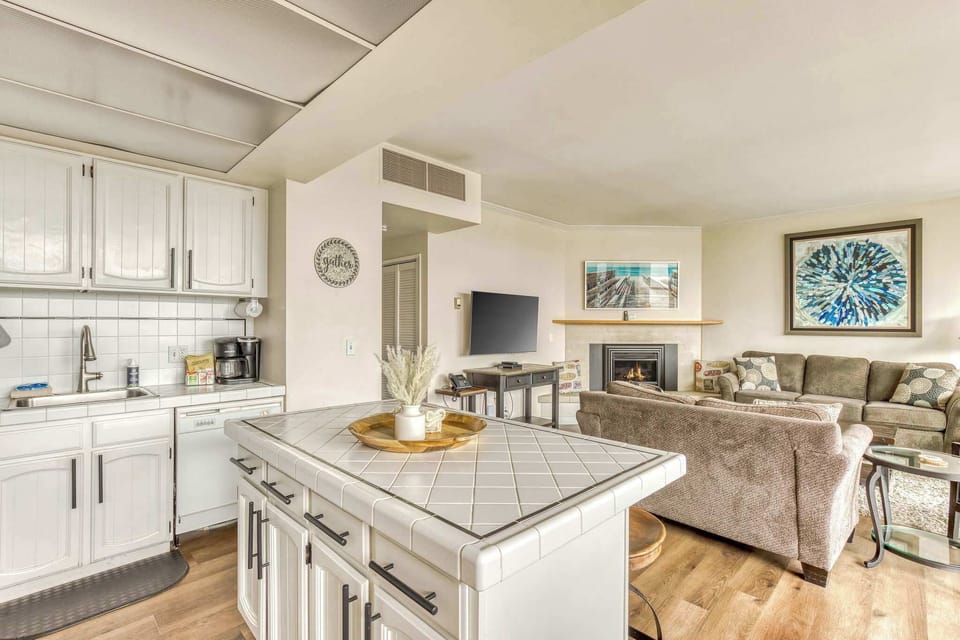 The island provides ample space to prep while also providing seating for company. Open floor plan means no one is missing out on the festivities!