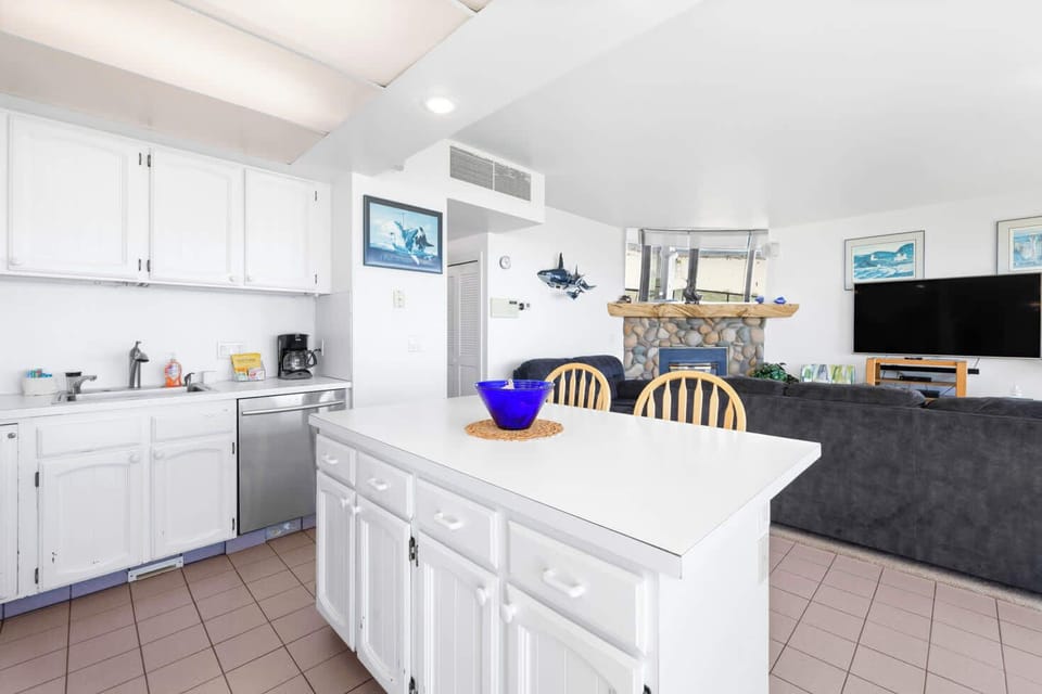 The island provides ample space to prep while also providing seating for company. Open floor plan means no one is missing out on the festivities!