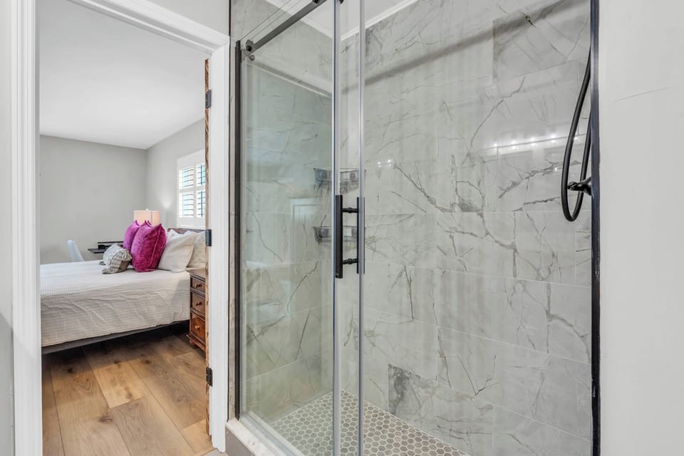 There is a glass enclosed shower in the en suite bathroom