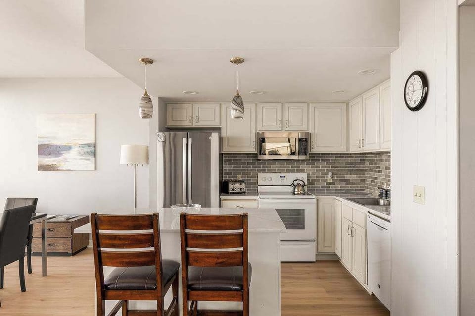 Bright, fully equipped kitchen with modern appliances and spacious island seating.