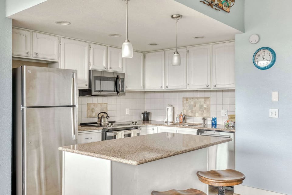 Prepare meals with ease! This functional kitchen offers essential appliances and a clean, practical space for cooking.