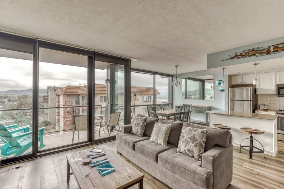 Views & vibes! Relax in our comfy living space with balcony access. Perfect for enjoying the scenery. 