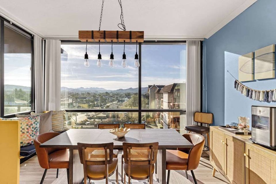 Gather around the dining table with scenic views and a bright, welcoming atmosphere.