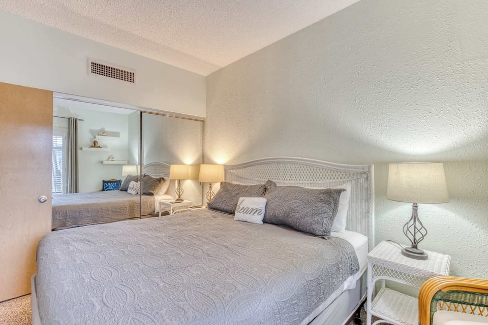 Relax and recharge in this generously sized bedroom, complete with a comfortable bed and charming decor.