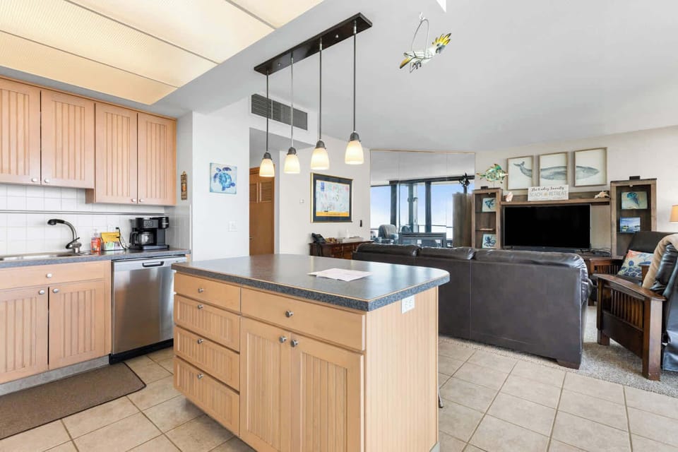 Your fully equipped kitchen in an open-concept setting! Features a spacious island, modern appliances, and seamless flow into the comfortable living area with a view.