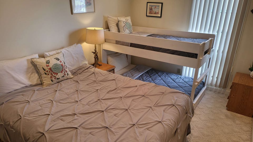 Ideal for children or extra guests, this bedroom features a full bed and convenient bunk beds.