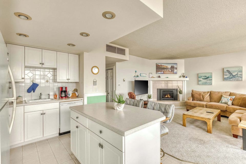 The kitchen island provides extra prep space and seating, seamlessly integrating with the inviting living room.