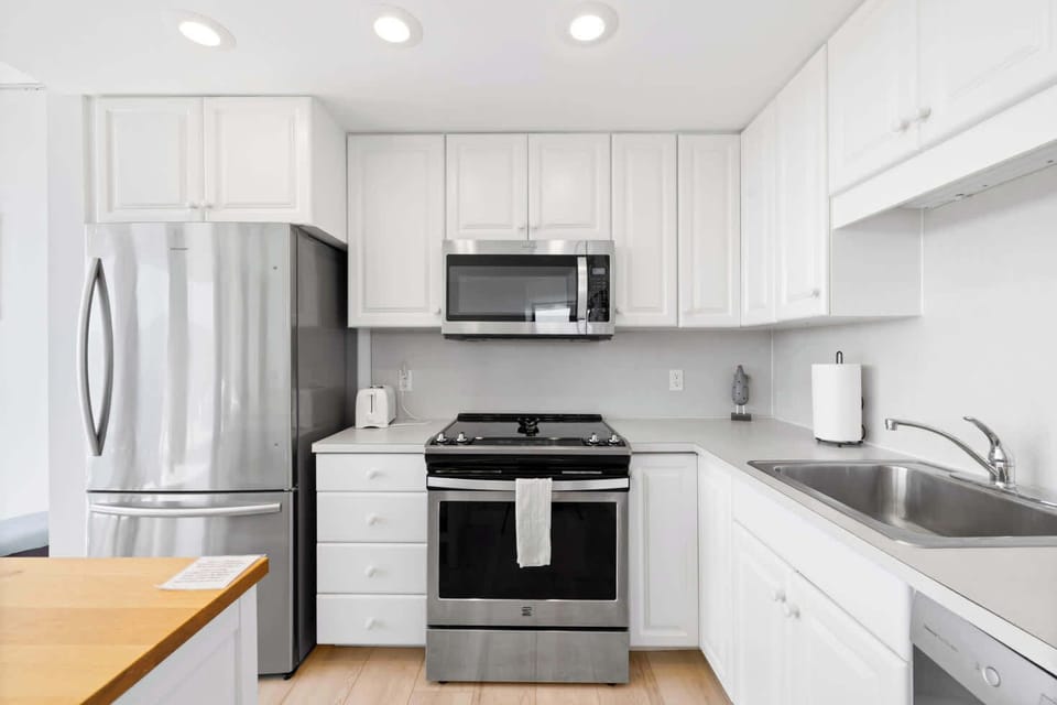 Functional kitchen providing essential appliances creating a clean and practical cooking space.