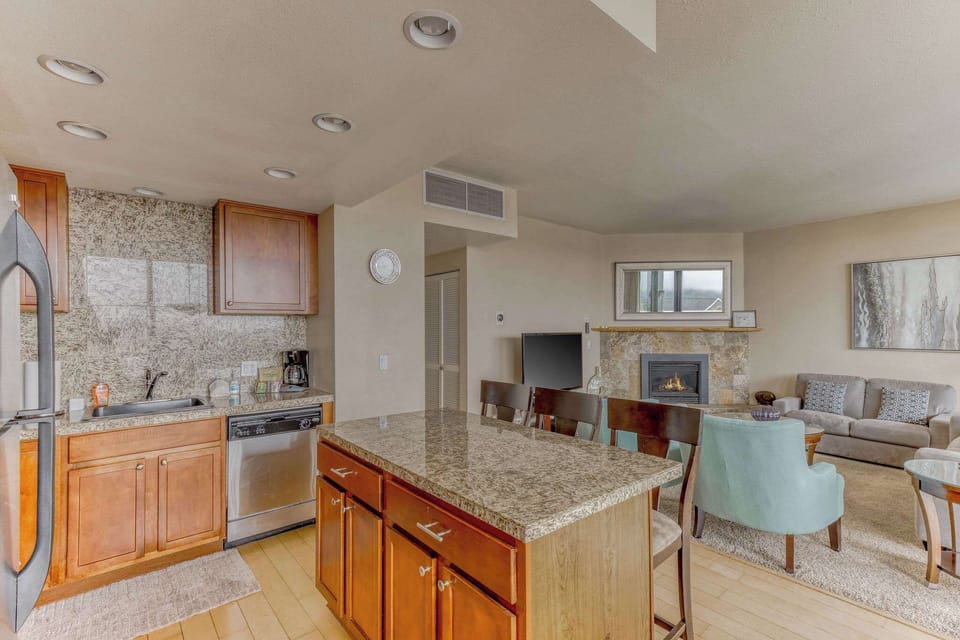 The island provides ample space to prep while also providing seating for company. Open floor plan means no one is missing out on the festivities!