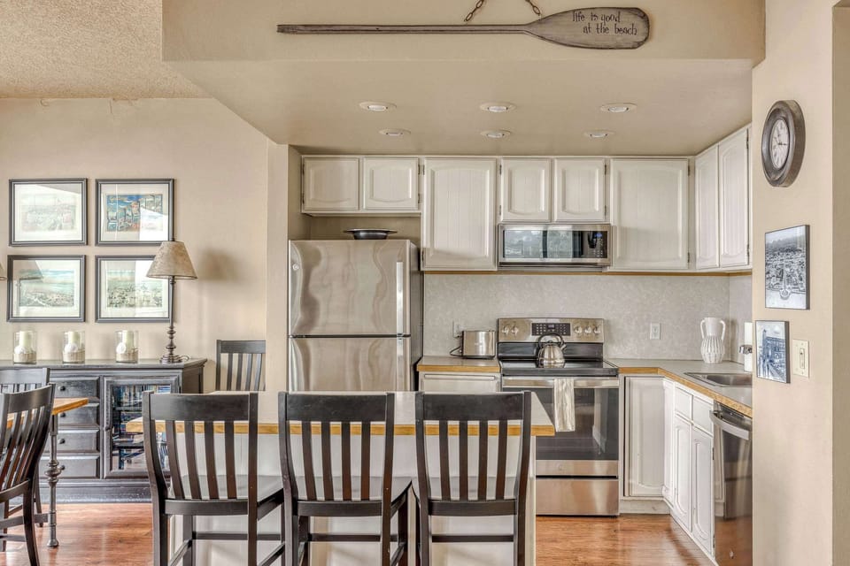 Your fully equipped kitchen with a coastal touch! Features sleek stainless steel appliances, ample counter space, and a breakfast bar for casual dining.
