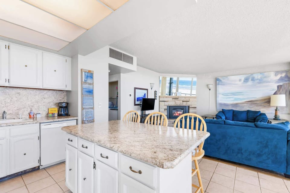 The island provides ample space to prep while also providing seating for company. Open floor plan means no one is missing out on the festivities!