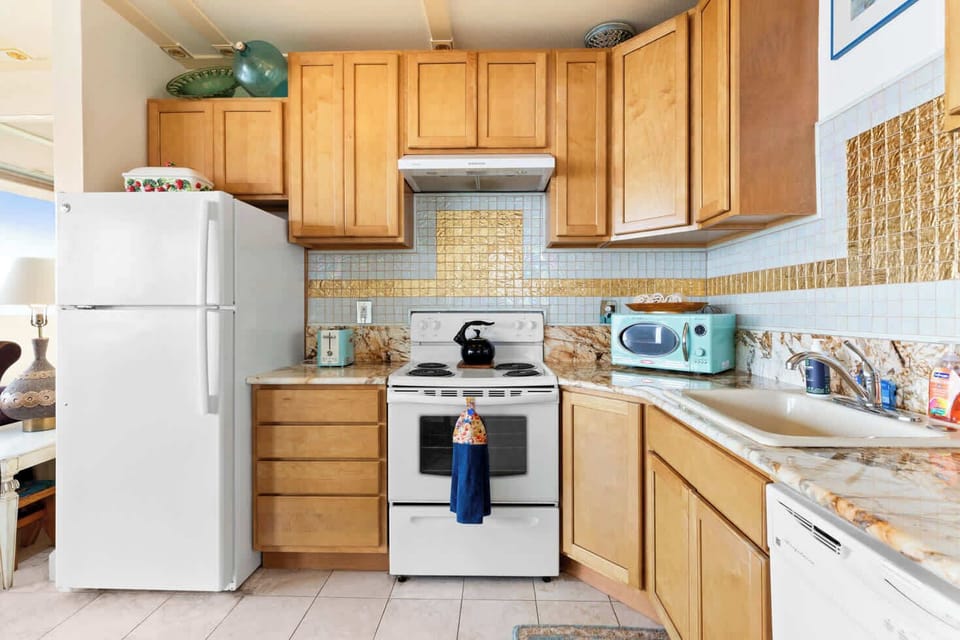 Functional kitchen providing essential appliances creating a clean and practical cooking space.