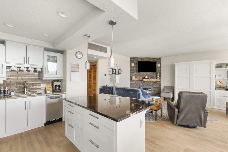 The island provides ample space to prep while also providing seating for company. Open floor plan means no one is missing out on the festivities!