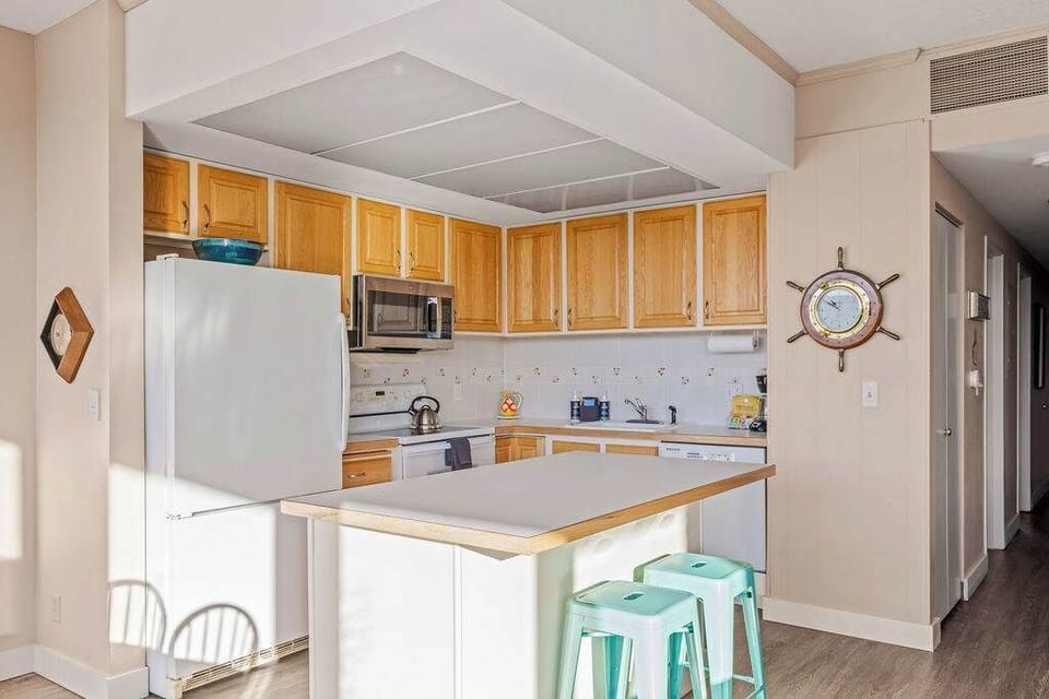 Fully equipped kitchen with full-size appliances, ample counter space, and seating—ideal for easy meals and snacks.