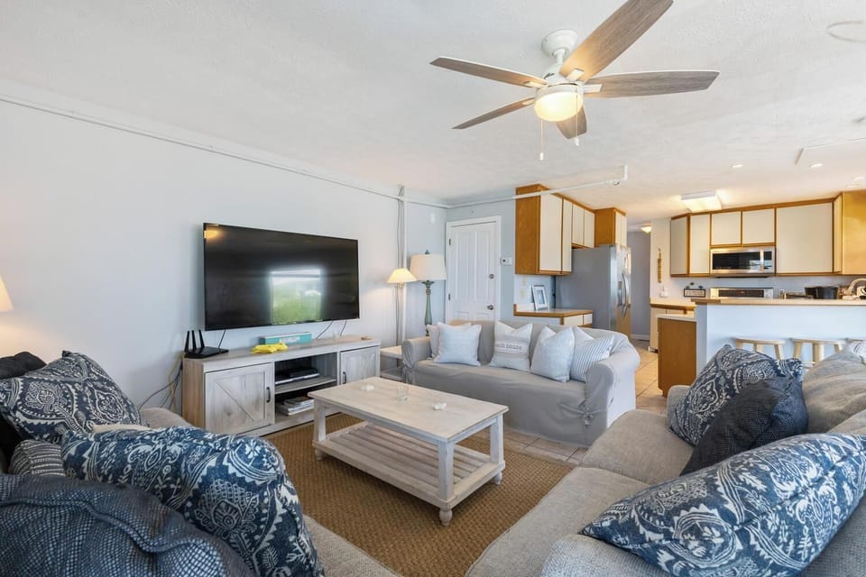 Settle into your coastal retreat where soft linens, charming wood tones, and thoughtful touches create a welcoming space for your beach getaway.