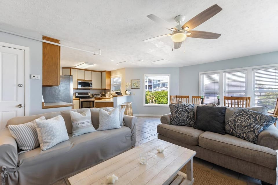 Relax in this inviting open-concept space with plush sofas, natural light, and a fully-equipped kitchen where you can cook and unwind like home.