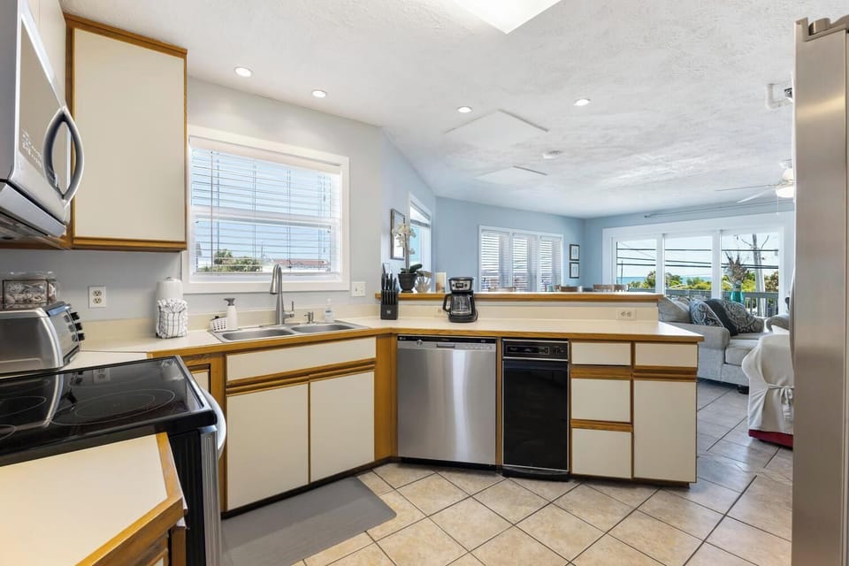 Bright, open kitchen with everything you need to prepare home-cooked meals, plus coastal views that make cooking feel like a vacation.