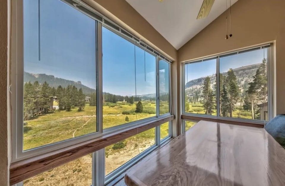 Enjoy serene views from the dining area, where large windows frame the natural beauty outside.