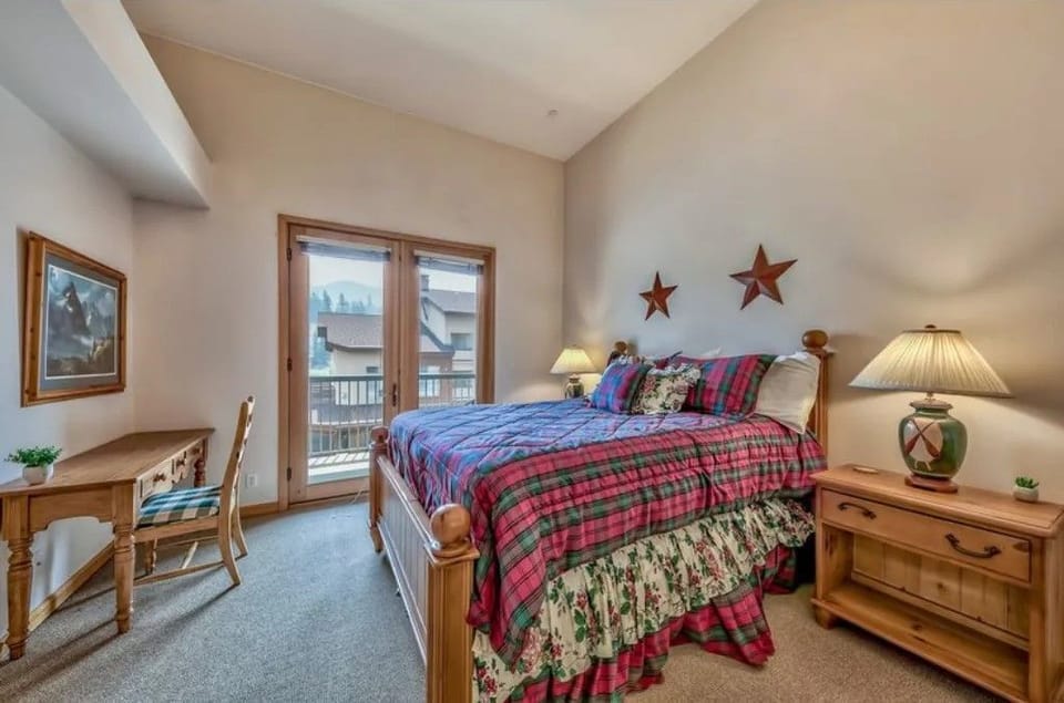 Relax in this inviting bedroom featuring a cozy king bed and warm decor, perfect for restful nights.