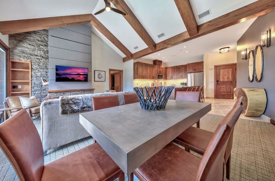 Dine in style in this beautifully appointed dining area, featuring a large table, stylish chairs, and views of the surrounding landscape.