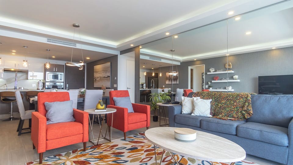 Large wall sized mirror above sofa
