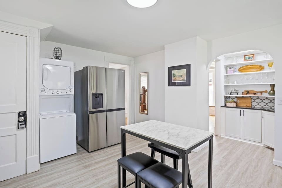 Inviting kitchen with cozy dining nook and well-stocked shelves ️☕ Enjoy a home-cooked meal in this lovely space.