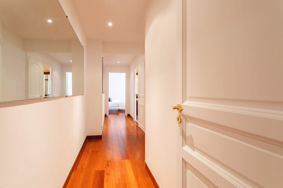 This bright hallway connects all the rooms in the apartment, providing smooth access from the bedrooms to the living room.