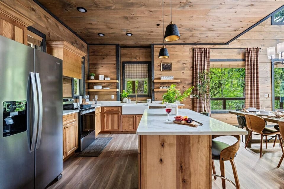 High-end finishes throughout the kitchen. It is equipped with cookware, glassware, plates, and silverware. Wine glasses are also provided.