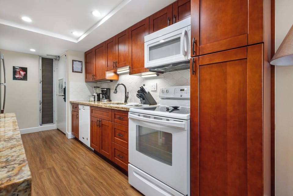 Your fully equipped kitchen awaits with gleaming appliances, warm cabinetry, and everything you need to prepare meals at home. The spacious countertops and modern conveniences make cooking a pleasure.