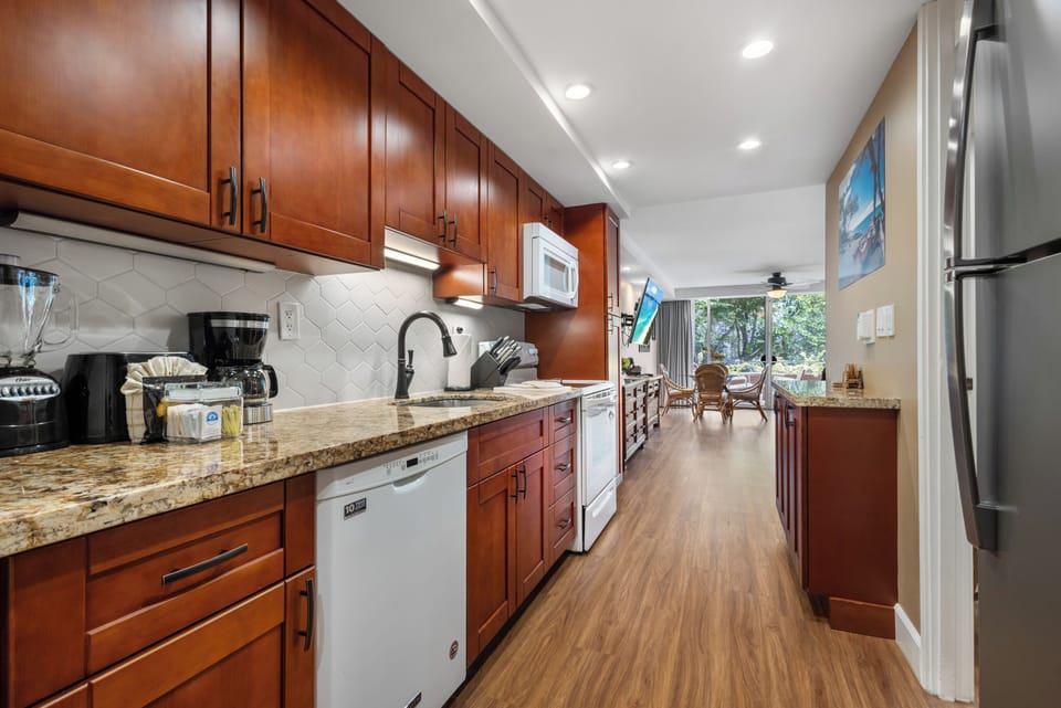 Step into your fully-equipped kitchen with granite counters, modern appliances, and a bright open layout that flows seamlessly into your dining and living spaces.