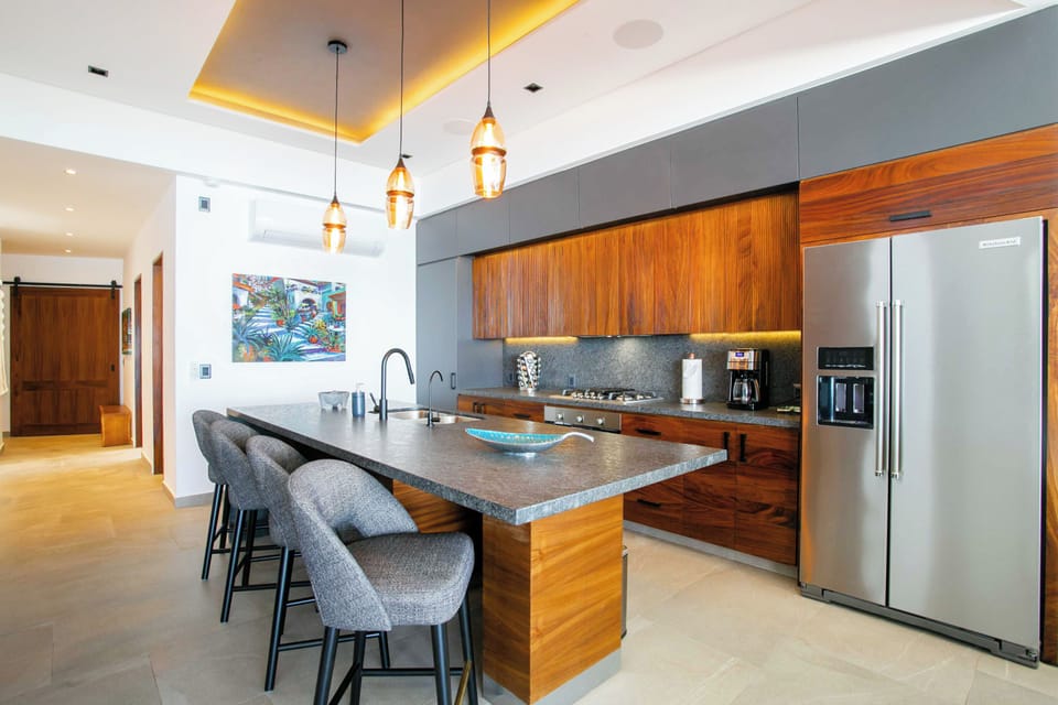 The fully-equipped kitchen amenities include a full-size fridge, stove, oven and dishwasher