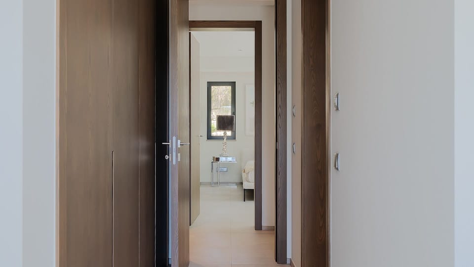 Step into serene luxury as this hallway invites you into a beautifully designed bedroom filled with soft, natural light. 

#Algarve #Portugal #InteriorDesign #LuxuryLiving #ModernHome