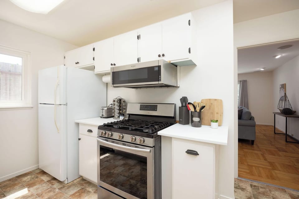 Fully equipped kitchen featuring stove, oven, fridge, and toaster
