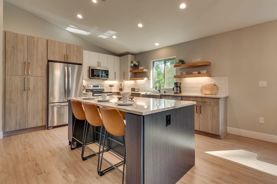 - Fully equipped kitchen with bar seating  
- Stainless steel appliances and modern cabinetry  
- Designed for cooking and entertaining with ease