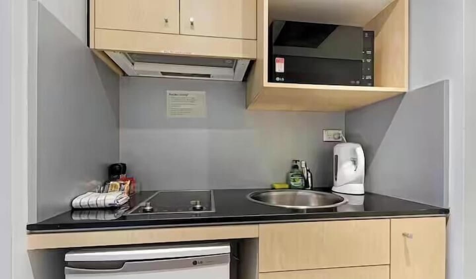 Clean kitchen area with convenient appliances