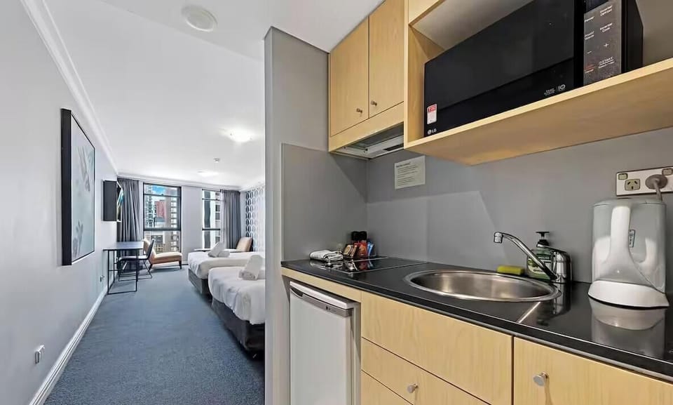 Clean kitchen area with convenient appliances
